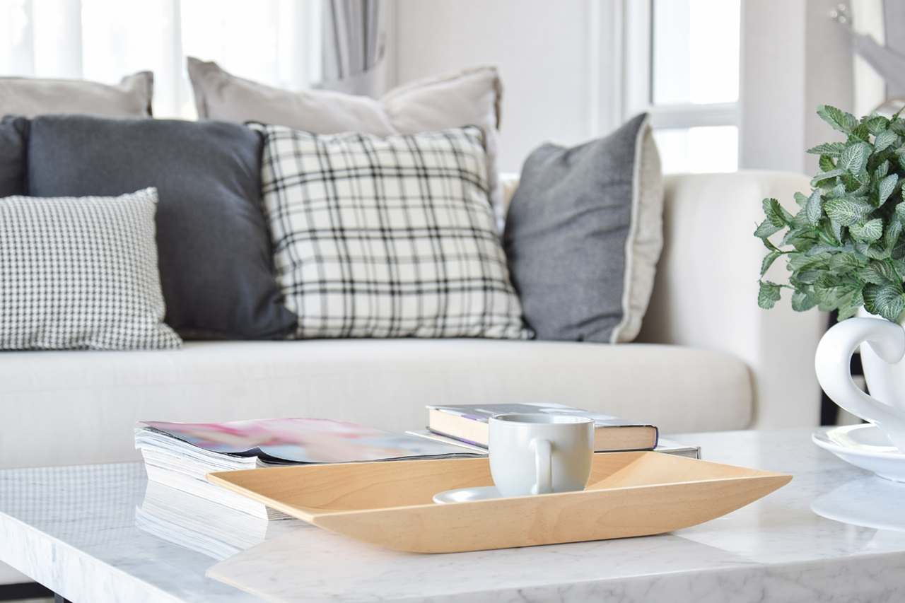 bandeja-de-madera-decorativa-con-taza-de-té-y-libros-en-el-interior-de-salón-moderno